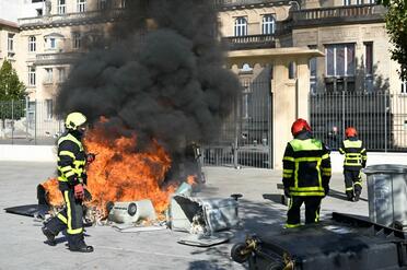 Firefighters arrive to extinguish a fire in front of Jean-Louis Cyffle high-school on the sidelines